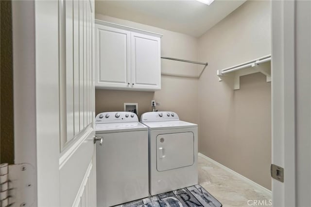 6125 Coopers Hawk Dr, Jurupa Valley, CA 91752 - laundry area featuring marble finish floors, washer and dryer, cabinet space, and baseboards