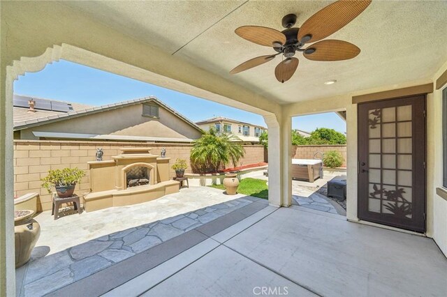 6125 Coopers Hawk Dr, Jurupa Valley, CA 91752 - fenced backyard featuring a patio area, ceiling fan, and an outdoor living space with a fireplace