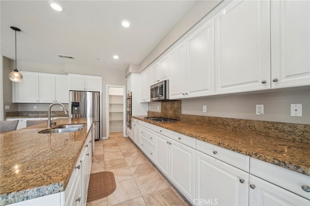 6125 Coopers Hawk Dr, Jurupa Valley, CA 91752 - kitchen featuring a sink, appliances with stainless steel finishes, white cabinets, recessed lighting, and stone countertops
