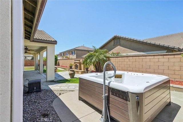6125 Coopers Hawk Dr, Jurupa Valley, CA 91752 - fenced backyard with a hot tub, a patio area, and a ceiling fan