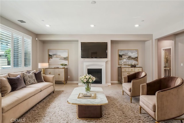 6125 Coopers Hawk Dr, Jurupa Valley, CA 91752 - living room featuring baseboards, a glass covered fireplace, and recessed lighting