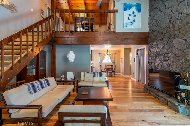 31045 Valley Oak Dr, Running Springs, CA 92382 - living room with a towering ceiling, wood finished floors, stairs, a chandelier, and beamed ceiling