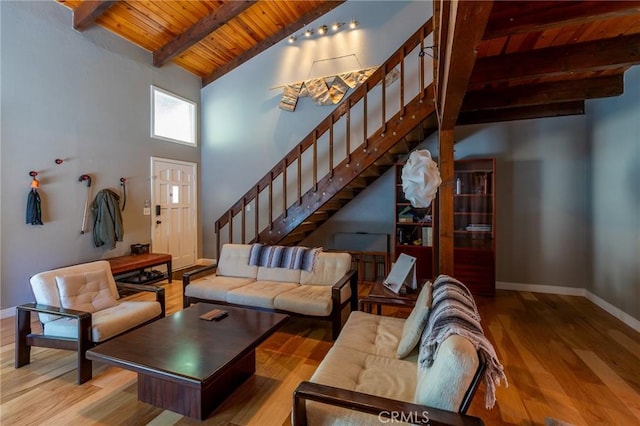 31045 Valley Oak Dr, Running Springs, CA 92382 - living area featuring wood ceiling with exposed beams, stairway, wood finished floors, baseboards, and high vaulted ceiling