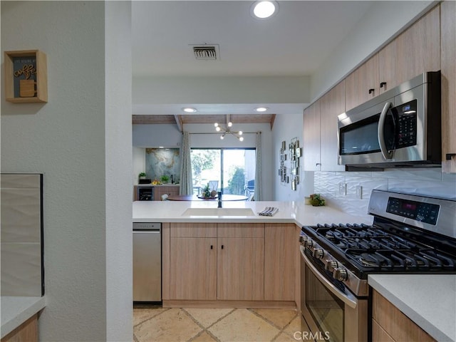 316 Forest Hills Dr, Rancho Mirage, CA 92270 - kitchen with stainless steel appliances, light brown cabinets, light countertops, and recessed lighting