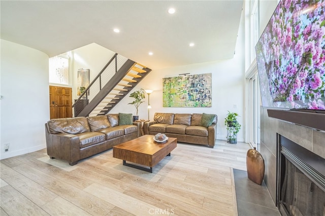528 San Andres Dr, Solana Beach, CA 92075 - living area with stairs, a fireplace, recessed lighting, light wood-style floors, and baseboards