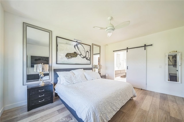 528 San Andres Dr, Solana Beach, CA 92075 - bedroom with wood finished floors, a barn door, baseboards, and a ceiling fan