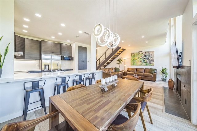 528 San Andres Dr, Solana Beach, CA 92075 - dining room with stairs, light wood finished floors, recessed lighting, and a fireplace