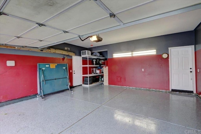 29567 Castlewood Dr, Menifee, CA 92584 - garage featuring baseboards and a garage door opener