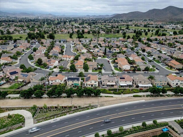 29567 Castlewood Dr, Menifee, CA 92584 - aerial view of property and surrounding area with a mountainous background and nearby suburban area