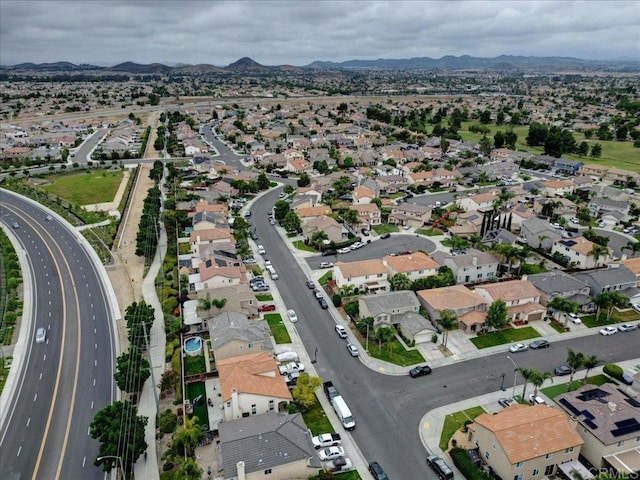 29567 Castlewood Dr, Menifee, CA 92584 - aerial overview of property's location with a mountain backdrop, nearby suburban area, and a main thoroughfare