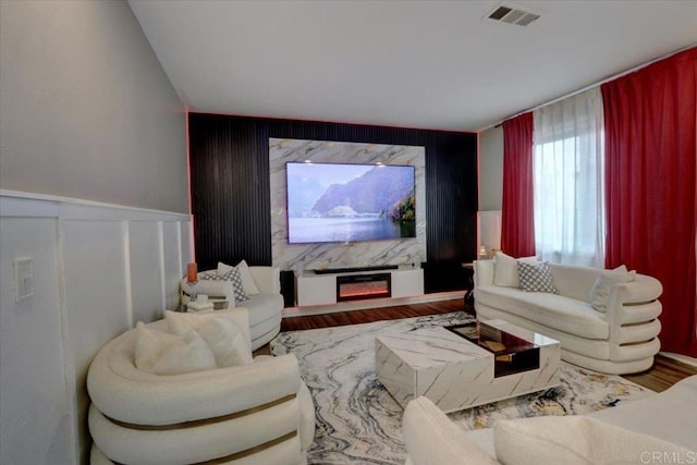 29567 Castlewood Dr, Menifee, CA 92584 - living room featuring an accent wall, wood finished floors, and a decorative wall