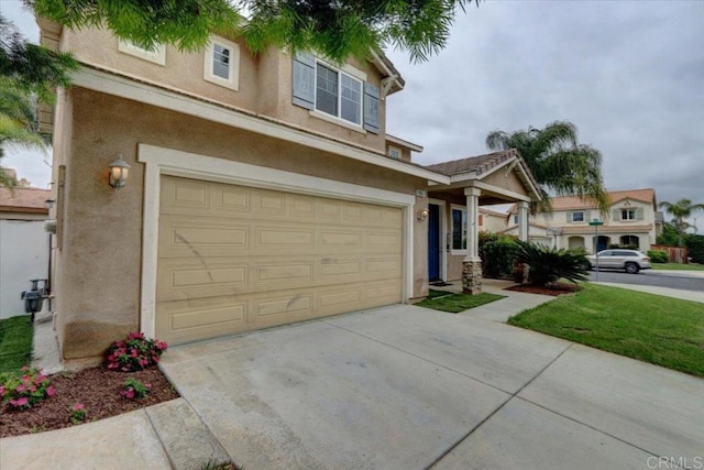 29567 Castlewood Dr, Menifee, CA 92584 - view of front facade with stucco siding, an attached garage, and driveway