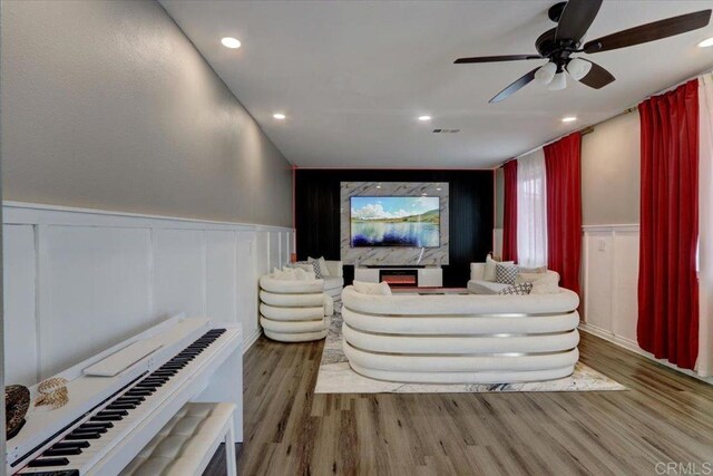 29567 Castlewood Dr, Menifee, CA 92584 - cinema room featuring wood finished floors, a wainscoted wall, ceiling fan, recessed lighting, and a decorative wall