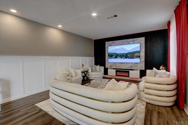 29567 Castlewood Dr, Menifee, CA 92584 - cinema room featuring a decorative wall, wood finished floors, recessed lighting, and a wainscoted wall