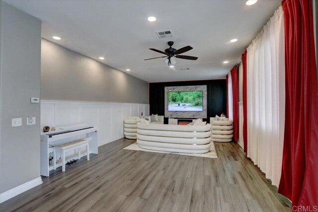 29567 Castlewood Dr, Menifee, CA 92584 - unfurnished living room featuring wood finished floors, ceiling fan, wainscoting, and recessed lighting