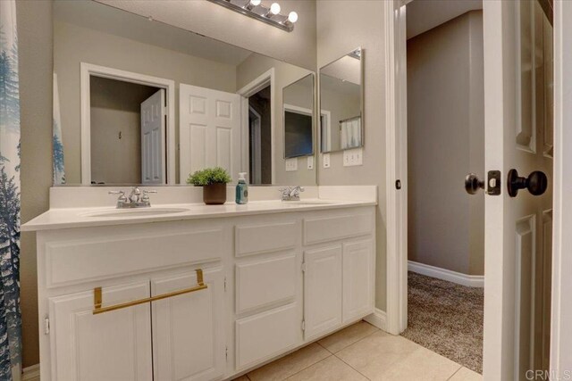 29567 Castlewood Dr, Menifee, CA 92584 - bathroom with double vanity, tile patterned floors, and baseboards