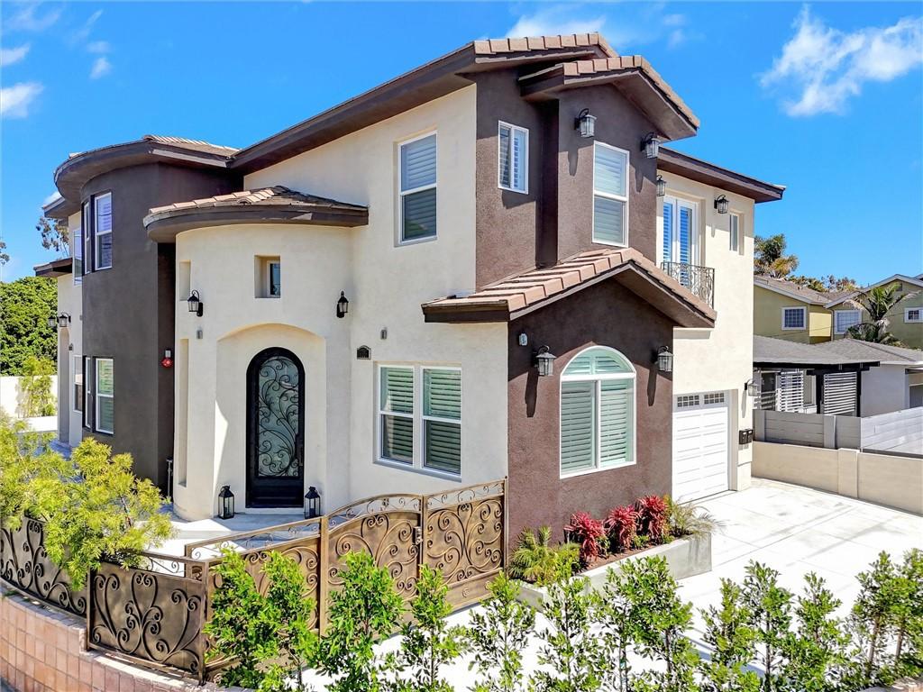 19002 Delaware St, Huntington Beach, CA 92648 - mediterranean / spanish house featuring a garage, a fenced front yard, driveway, a tiled roof, and stucco siding