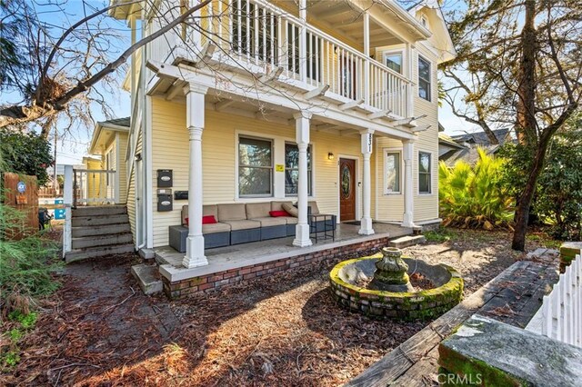 831 Rio Chico Way, Chico, CA 95928 - back of house with a balcony, an outdoor living space, and covered porch