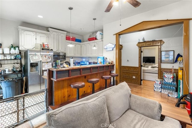 831 Rio Chico Way, Chico, CA 95928 - kitchen featuring stainless steel appliances, white cabinetry, light wood-style floors, a peninsula, and ceiling fan
