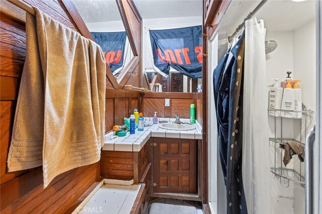 831 Rio Chico Way, Chico, CA 95928 - bathroom with vanity, wooden walls, and curtained shower