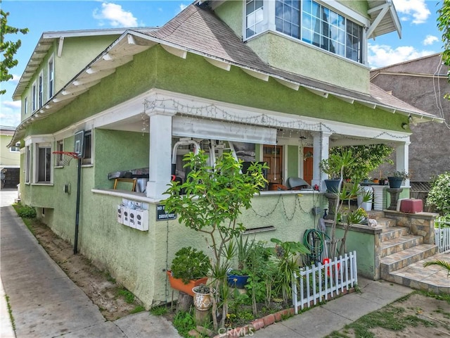 1522 2nd Ave, Los Angeles, CA 90019 - view of side of property featuring stucco siding and roof with shingles