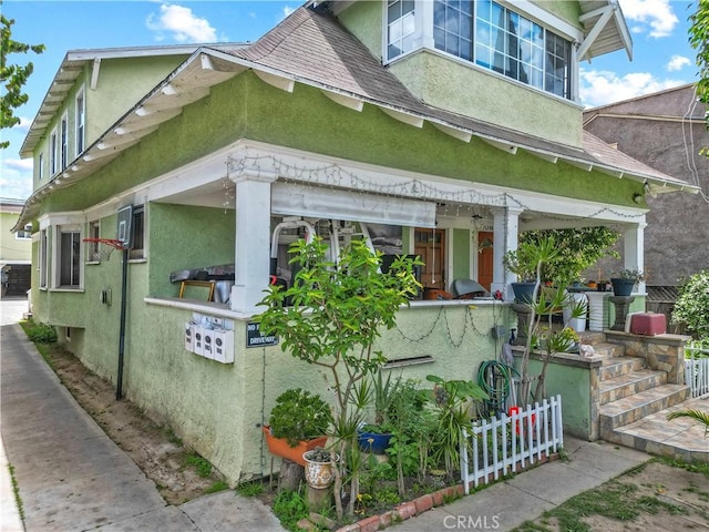 1522 2nd Ave, Los Angeles, CA 90019 - view of side of property with stucco siding and roof with shingles