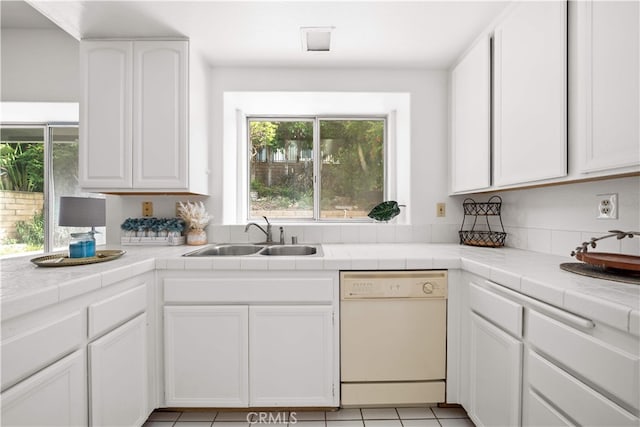 10274 Corkwood Ct, Rancho Cucamonga, CA 91737 - kitchen with white dishwasher, a sink, white cabinets, and tile counters