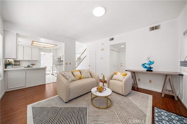 10274 Corkwood Ct, Rancho Cucamonga, CA 91737 - living area with wood finished floors, baseboards, and stairway