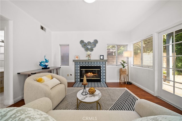 10274 Corkwood Ct, Rancho Cucamonga, CA 91737 - living area with healthy amount of natural light, wood finished floors, a tiled fireplace, and baseboards