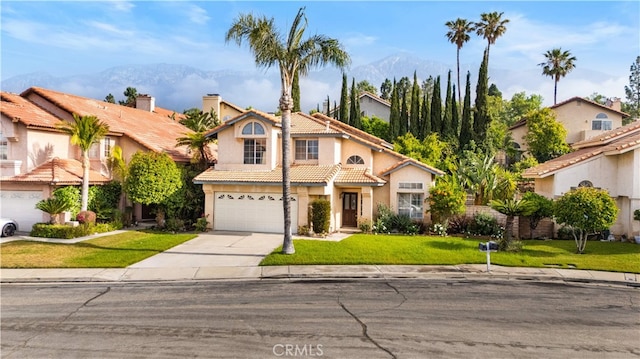 10274 Corkwood Ct, Rancho Cucamonga, CA 91737 - view of front of house with a mountain view, concrete driveway, a tiled roof, and an attached garage