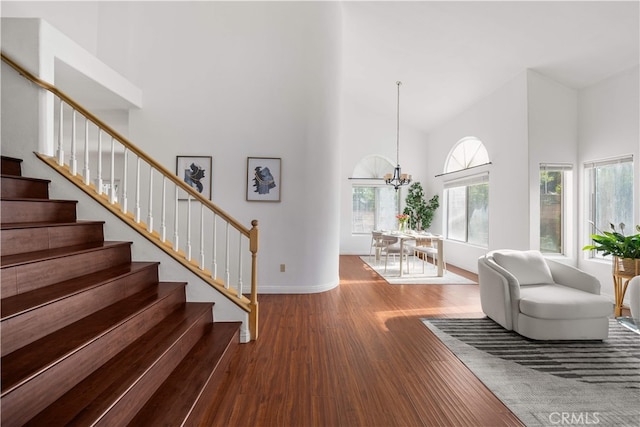 10274 Corkwood Ct, Rancho Cucamonga, CA 91737 - living area featuring high vaulted ceiling, wood finished floors, stairway, a chandelier, and baseboards