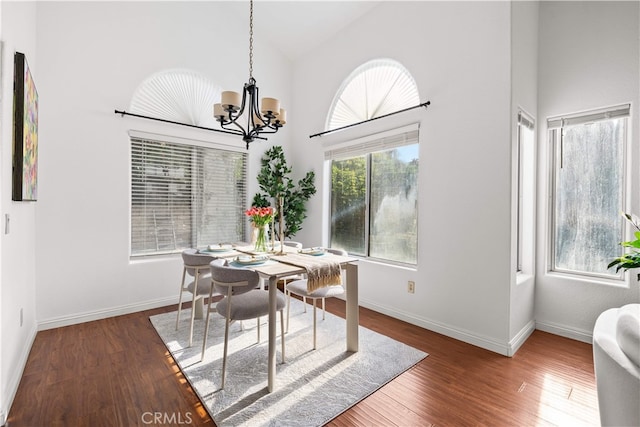 10274 Corkwood Ct, Rancho Cucamonga, CA 91737 - dining area with a chandelier, wood finished floors, high vaulted ceiling, and baseboards