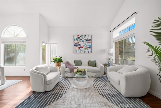 10274 Corkwood Ct, Rancho Cucamonga, CA 91737 - living area with wood finished floors, a towering ceiling, and baseboards