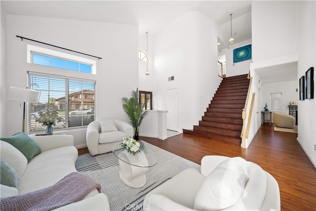 10274 Corkwood Ct, Rancho Cucamonga, CA 91737 - living area featuring a high ceiling, wood finished floors, stairs, and baseboards