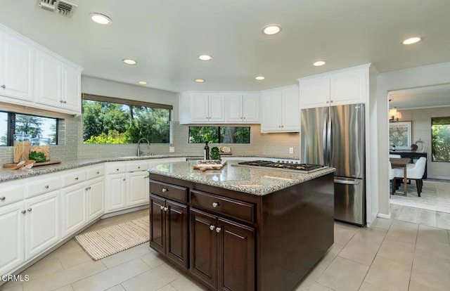 2320 Mountain Ave, La Crescenta, CA 91214 - kitchen with freestanding refrigerator, gas stovetop, recessed lighting, dark brown cabinets, and decorative backsplash