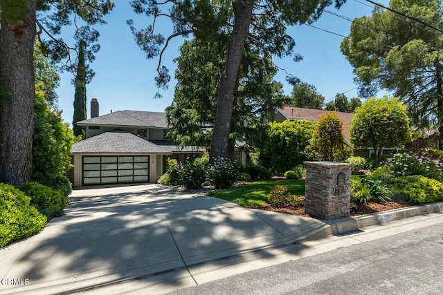 2320 Mountain Ave, La Crescenta, CA 91214 - view of front facade with concrete driveway, a garage, and a chimney