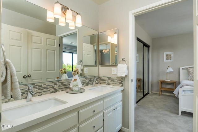 2320 Mountain Ave, La Crescenta, CA 91214 - ensuite bathroom featuring a chandelier, decorative backsplash, double vanity, and baseboards