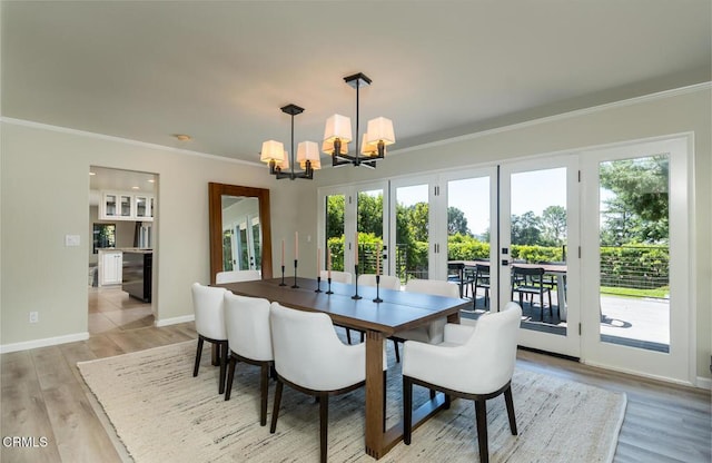2320 Mountain Ave, La Crescenta, CA 91214 - dining area featuring a chandelier, ornamental molding, light wood finished floors, and baseboards