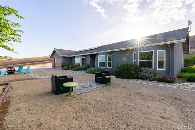 2750 Lazy Hill Rd, San Miguel, CA 93451 - view of front of property with an outdoor fire pit, stucco siding, and solar panels