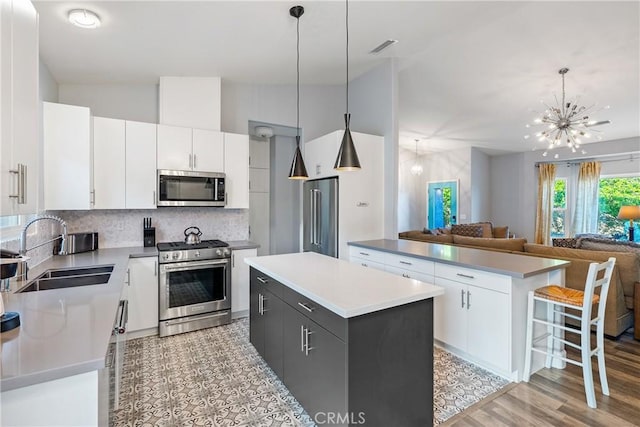 2750 Lazy Hill Rd, San Miguel, CA 93451 - kitchen with stainless steel appliances, a sink, a kitchen island, a chandelier, and open floor plan