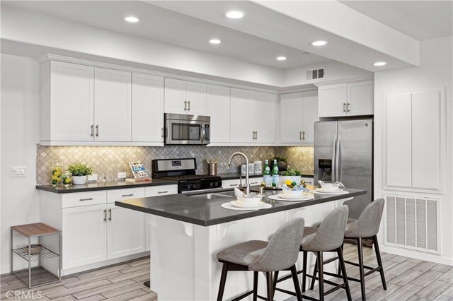 405 Mallorca Ln, Brea, CA 92823 - kitchen featuring stainless steel appliances, a sink, dark countertops, light wood finished floors, and recessed lighting