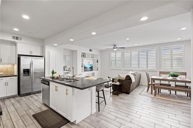405 Mallorca Ln, Brea, CA 92823 - kitchen with appliances with stainless steel finishes, a sink, dark countertops, wood finish floors, and recessed lighting