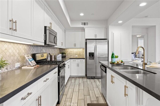 405 Mallorca Ln, Brea, CA 92823 - kitchen with appliances with stainless steel finishes, a sink, dark countertops, white cabinetry, and recessed lighting