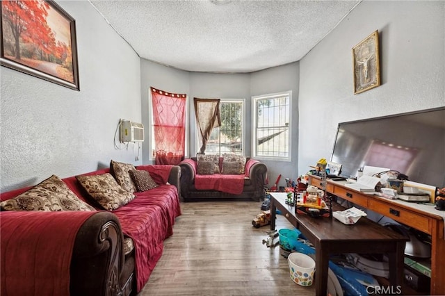 673 W 9th St, San Bernardino, CA 92410 - living area with a textured ceiling, a textured wall, wood finished floors, and a wall mounted AC