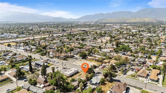 673 W 9th St, San Bernardino, CA 92410 - aerial view of property and surrounding area featuring a mountain backdrop and nearby suburban area