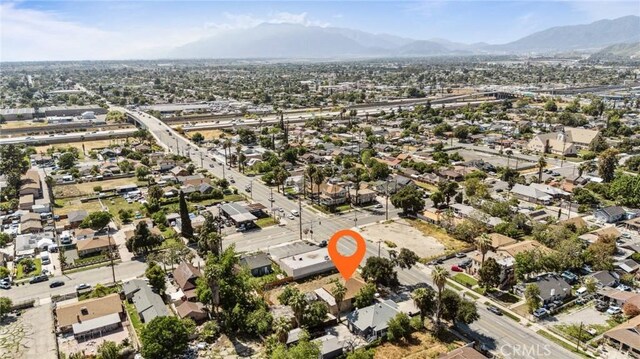 673 W 9th St, San Bernardino, CA 92410 - aerial overview of property's location with a mountainous background and nearby suburban area