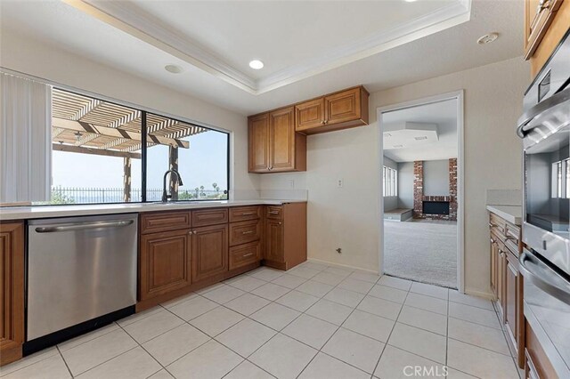 16227 Glencove Dr, Hacienda Heights, CA 91745 - kitchen featuring dishwasher, brown cabinetry, light countertops, a raised ceiling, and crown molding