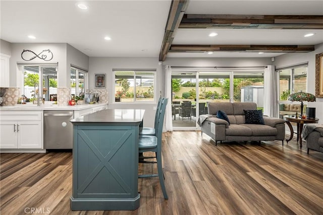 1624 Kingston Rd, Placentia, CA 92870 - kitchen with stainless steel dishwasher, white cabinetry, open floor plan, beamed ceiling, and tasteful backsplash