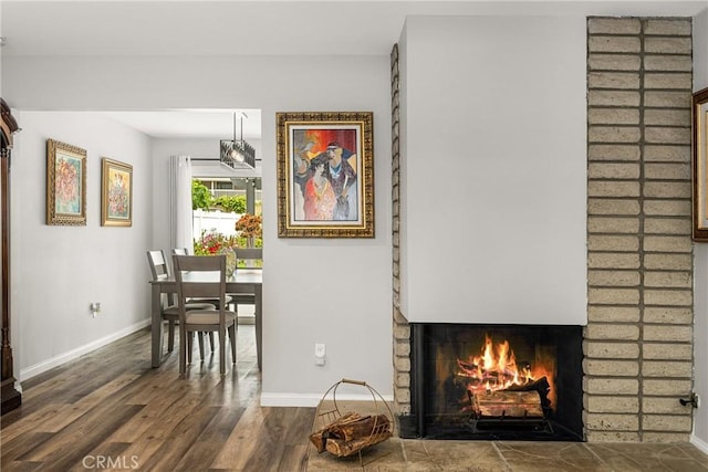 1624 Kingston Rd, Placentia, CA 92870 - dining space featuring baseboards, wood finished floors, and a fireplace