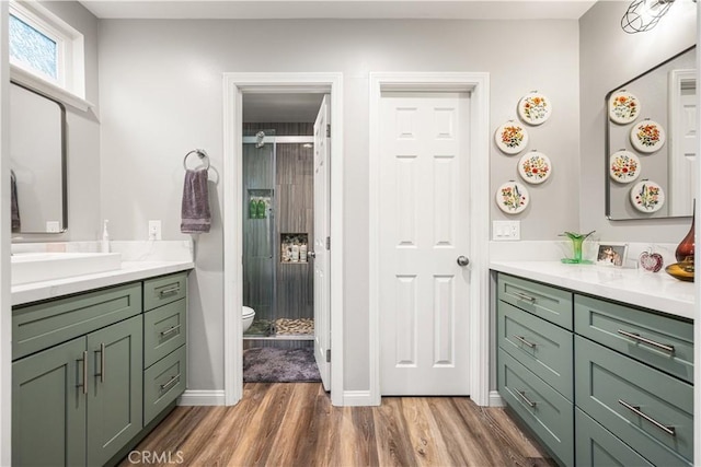 1624 Kingston Rd, Placentia, CA 92870 - full bathroom featuring wood finished floors, a shower stall, vanity, toilet, and baseboards
